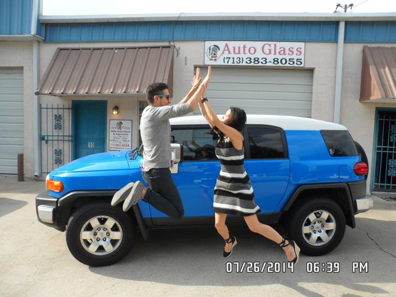 Two happy clients jumping for joy at Able Auto Glass in Houston, TX.